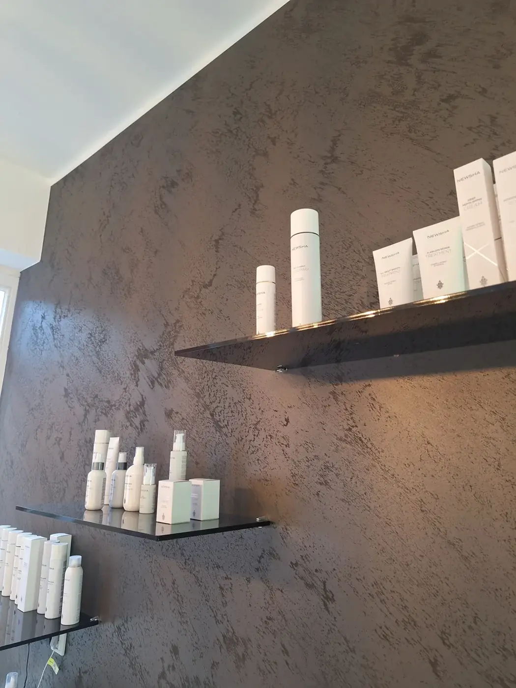 Metallic-Wand im Salon: Kreativtechnik mit Metalleffekt als Blickfang hinter den Regalen